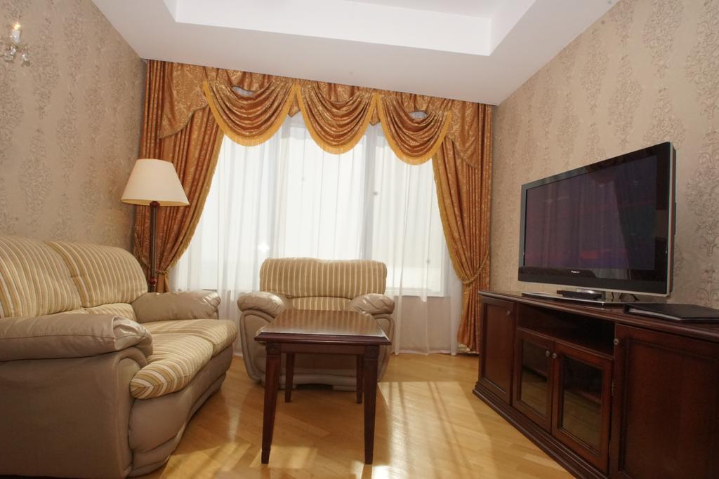 Grand Hotel Victory Aktau  Exterior photo A living room with a television